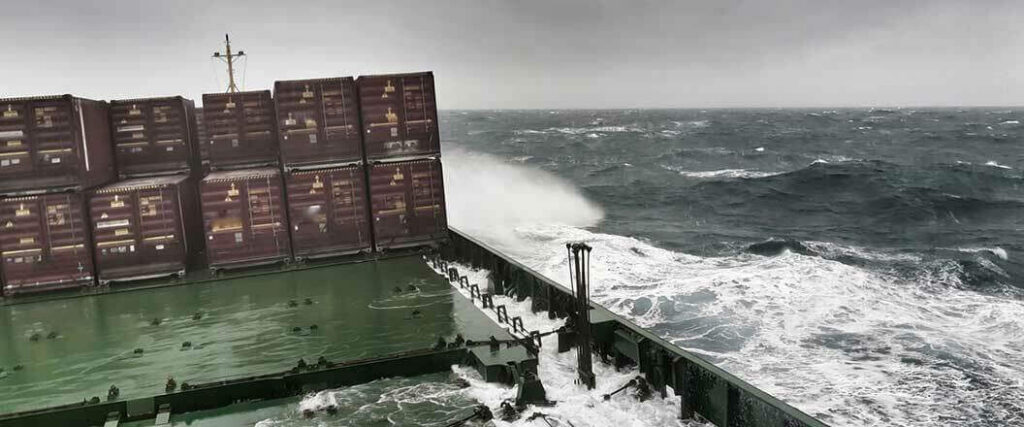 Giant waves crashing into a cargo ship transporting containers