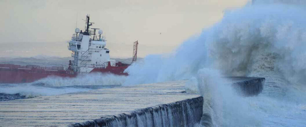 Large waves crashing into this ship show why hurricane cargo insurance is essential