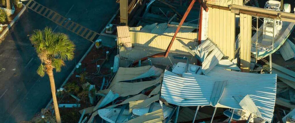 Hurricane proparation for businesses can help reduce damage such as the destroyed aluminum buildings in this image.