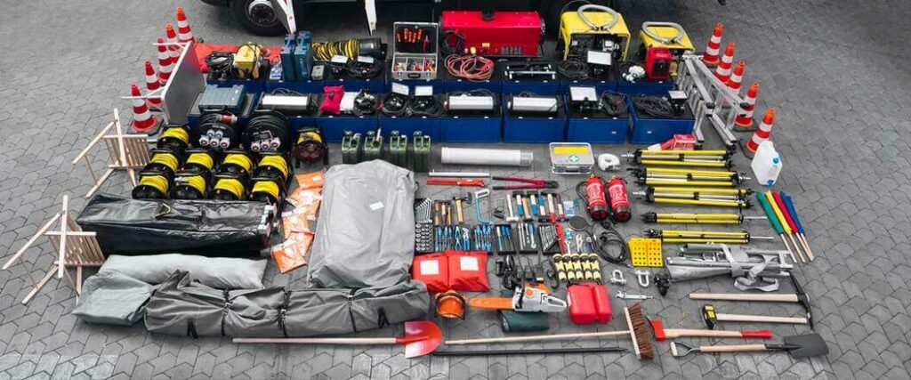 An emergency supply kit with shovels, signal flags, tools, fire hydrants, a chainsaw, and more.