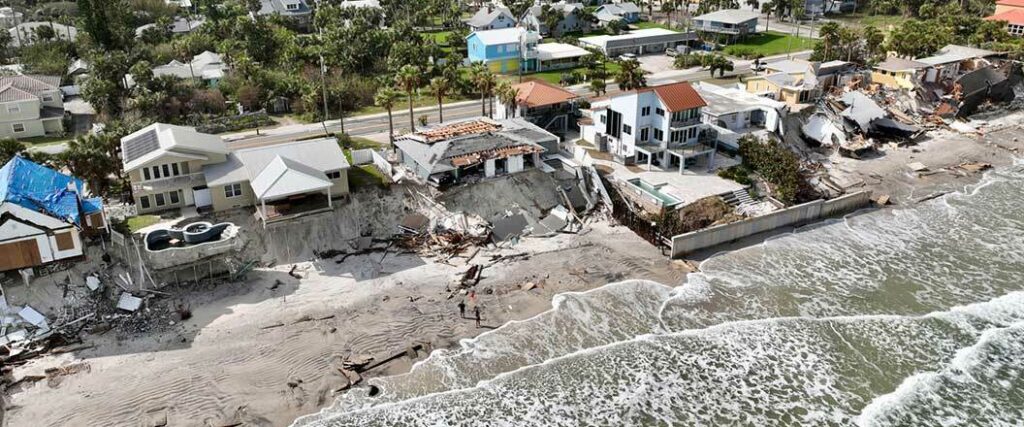 A beachside residential neighborhood suffering the aftermath of a hurricane. 